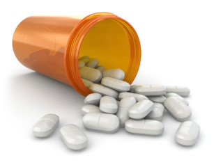 Medicine concept. Spilled pills from prescription bottle.
