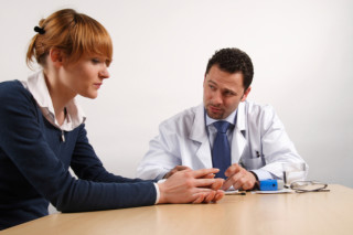 bad news - doctor talking to female patient