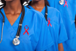 african medical doctors with red ribbon