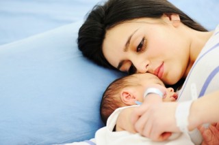 Woman holding her newborn baby at hospital